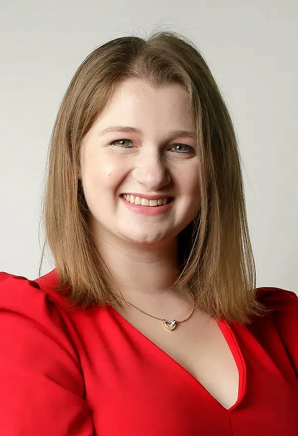 A person in red dress and blonde hair
