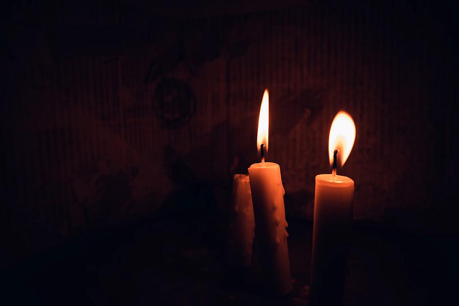 Two Candles Lit Inside a Dark Room