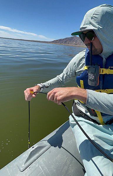 Person taking water sample from the Salton Sea