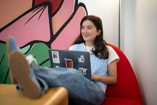 A women sitting with a laptop 