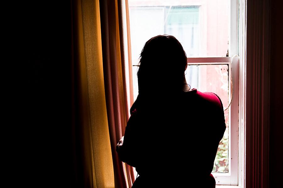 Person standing in balcony against light