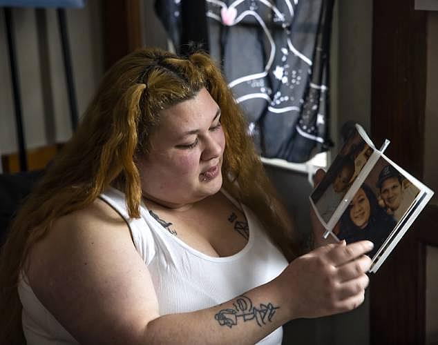 Woman looks at photo album with family pictures.