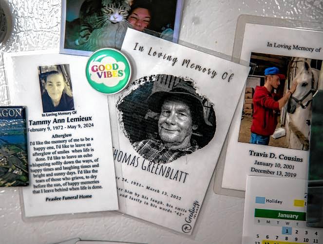 Refrigerator with memorial cards and photos.