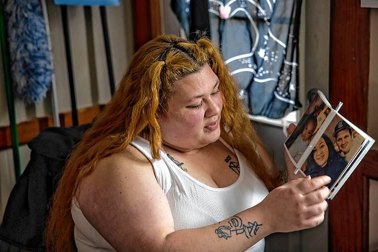 Woman looks at photo album with family pictures.