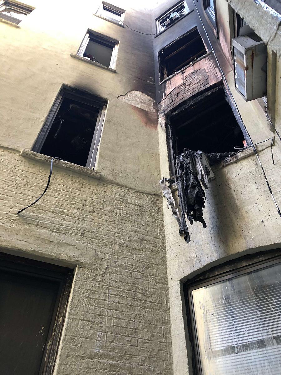 Building with broken windows and burnt walls after fire