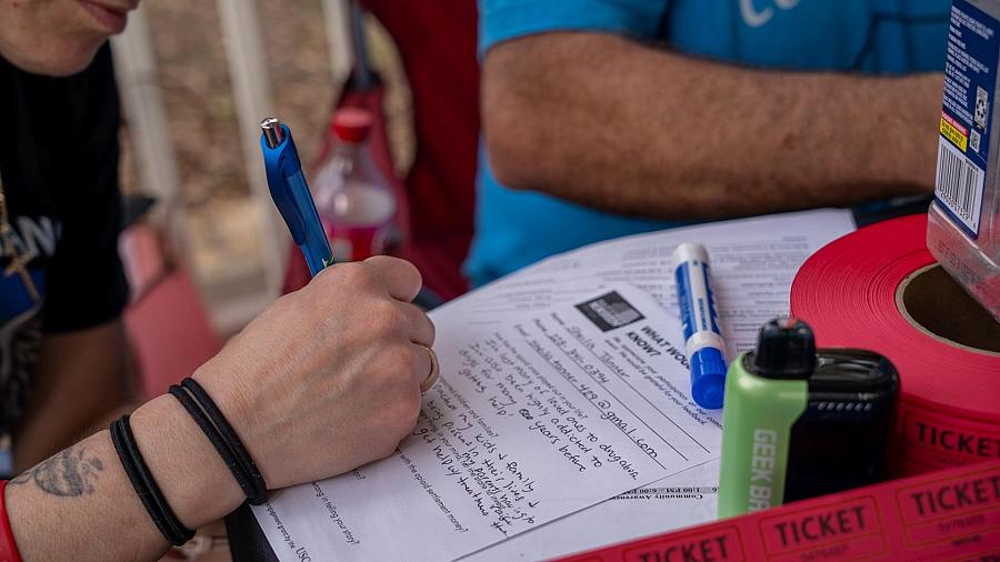A person filling out a form