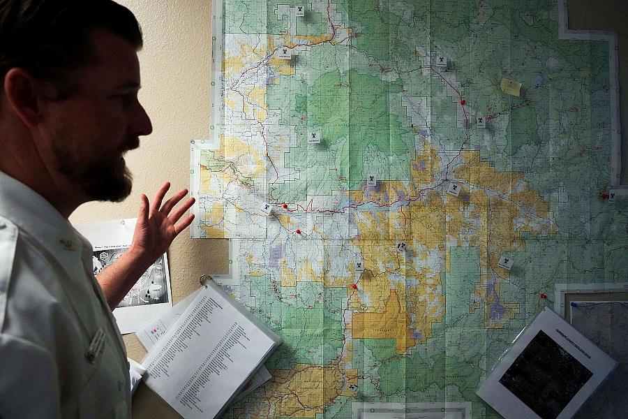 Image of a person with the map on wall