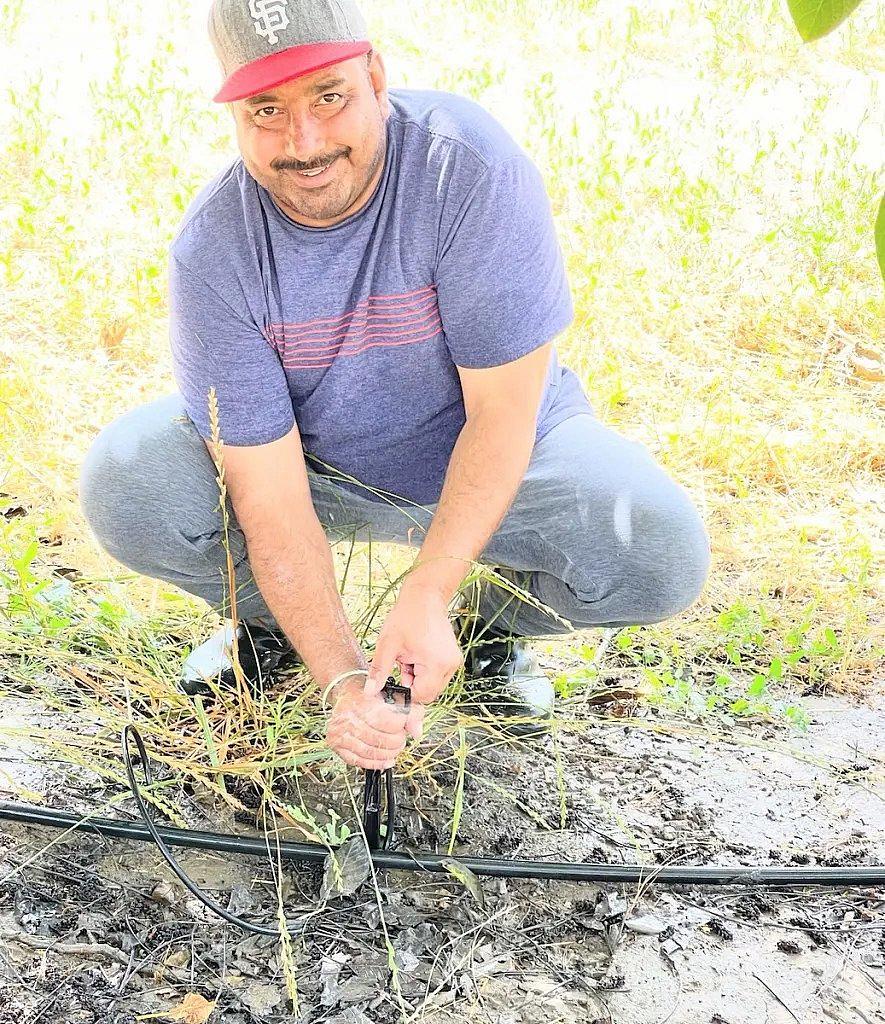 Image of a person with cap working in a farm