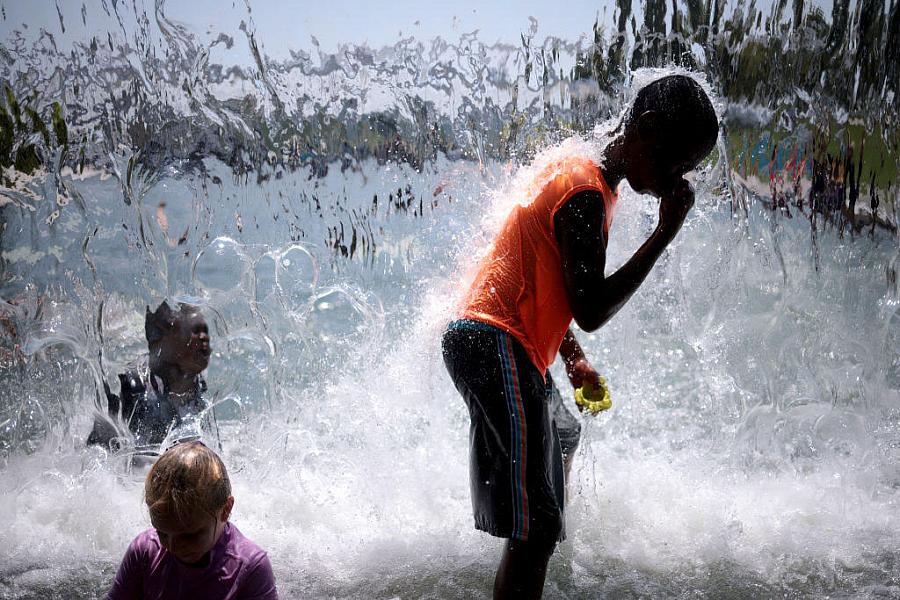 children standing close to flowing water