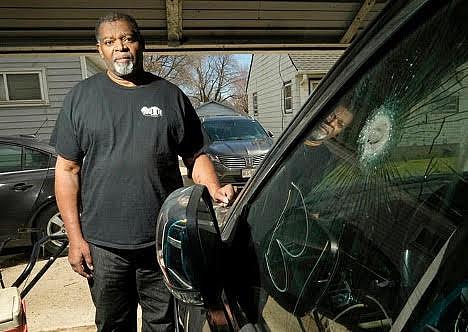 Pastor Kevin Simmons, who was shot during a carjacking, stands next to the Jeep he was in when he was shot