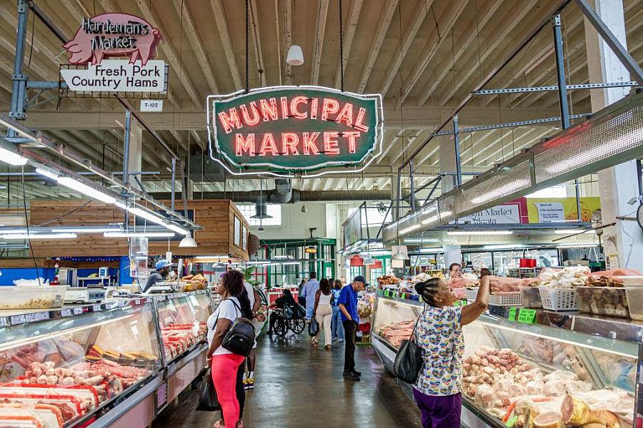 Large room with lit up market sign