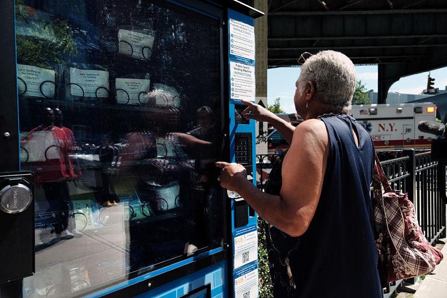 Person pressing a button o[n a vending machine