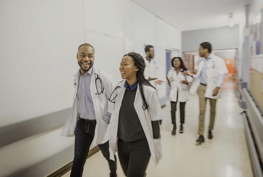 People in white coats walking