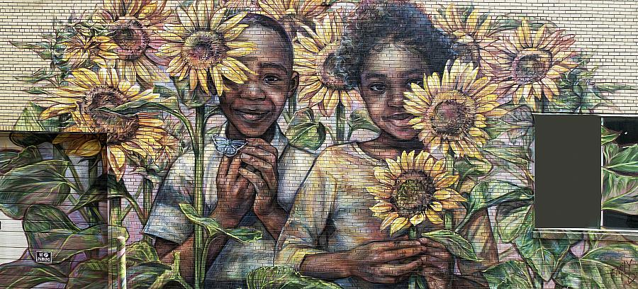 Wall mural of 2 children surrounded by sunflowers