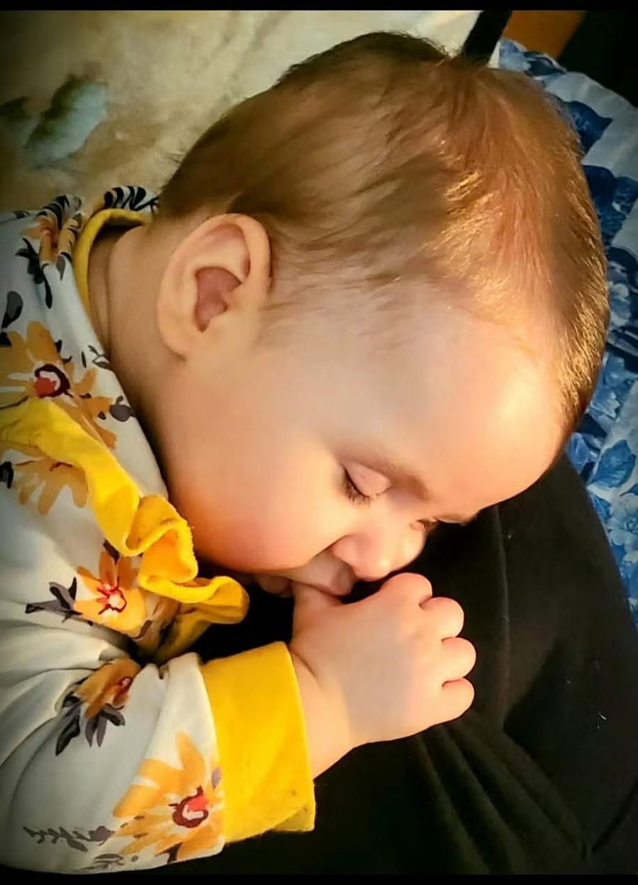 A toddler sucking on their thumb