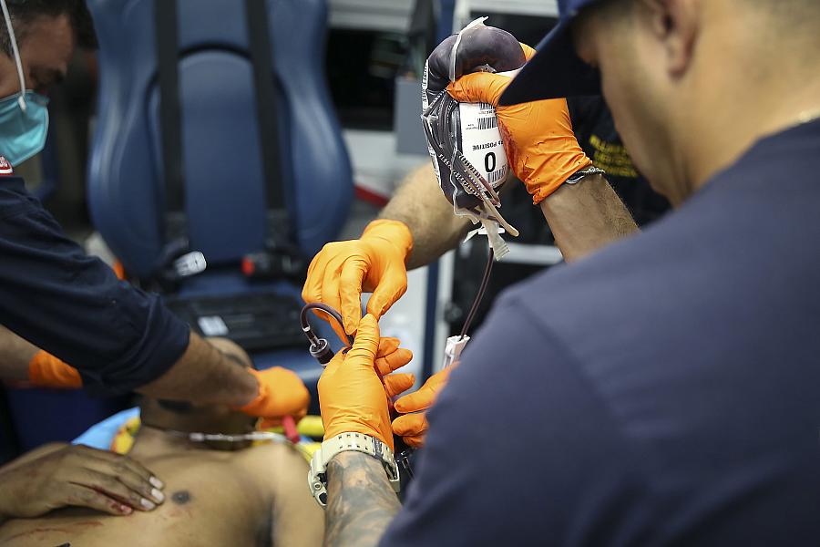 Image of paramedics helping a victim