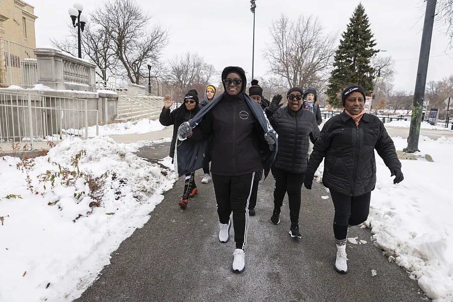 A group of people walking on a street