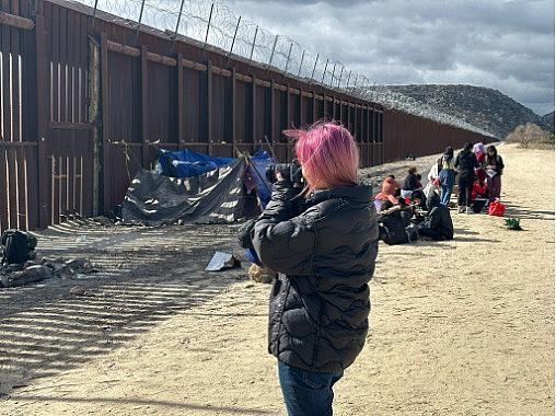 A person standing at the border or US-Mexico
