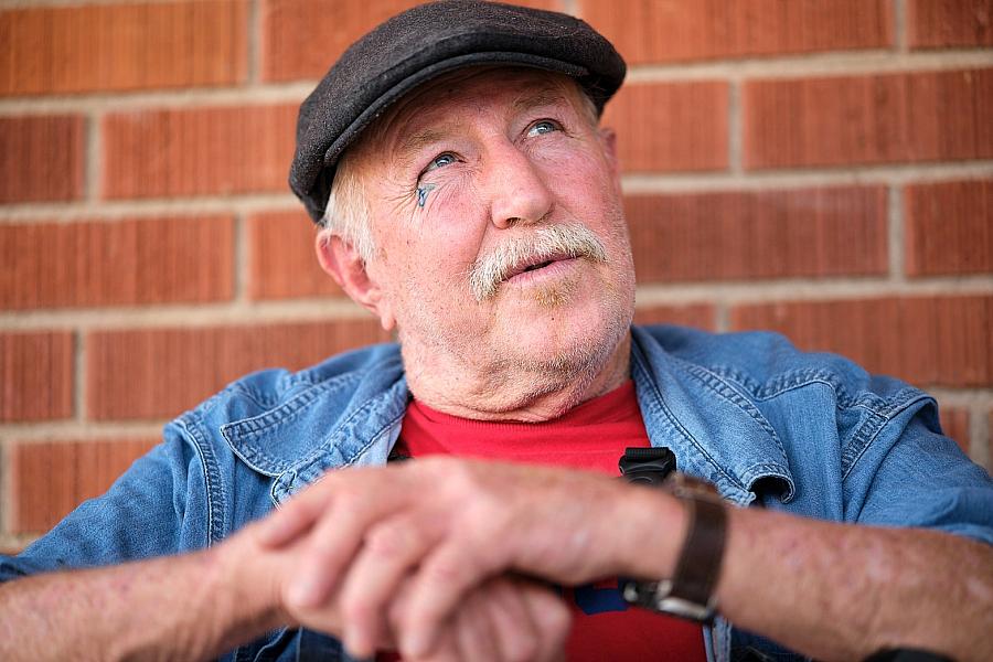 Person in a cap against a brick wall