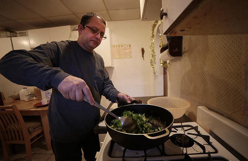 Tek Nepal prepares dry curry for that day's lunch. &quot;I try to eat a lot of green vegetables like lettuce, spinach … carrots, and I don’t eat totally fried things,&quot; he said. (Ryan Loew/90.5 WESA)