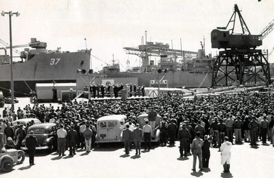 Hundreds of workers gathered on shipyards listening to a speech in 1949