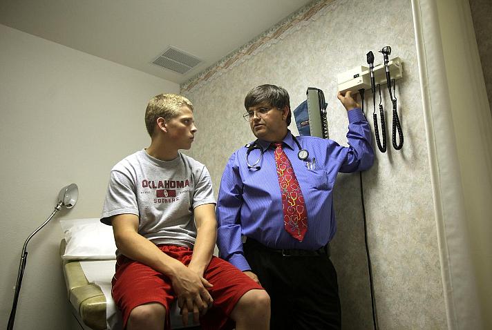 Dr. Michael Woods of Ramona treats Randy Ramsey, 17, of Vera, for a small granuloma. Woods is one of few doctors in the state do