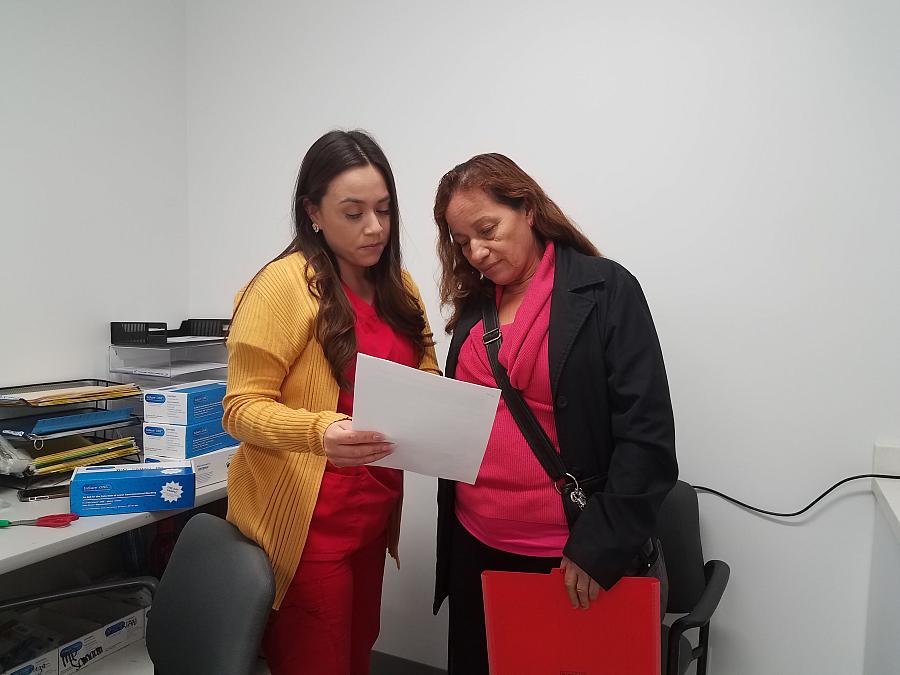  Medical assistant Deisy Hernandez discusses an upcoming appointment with patient Caya Mendoza, 62, inside Clinica Romero in Boy
