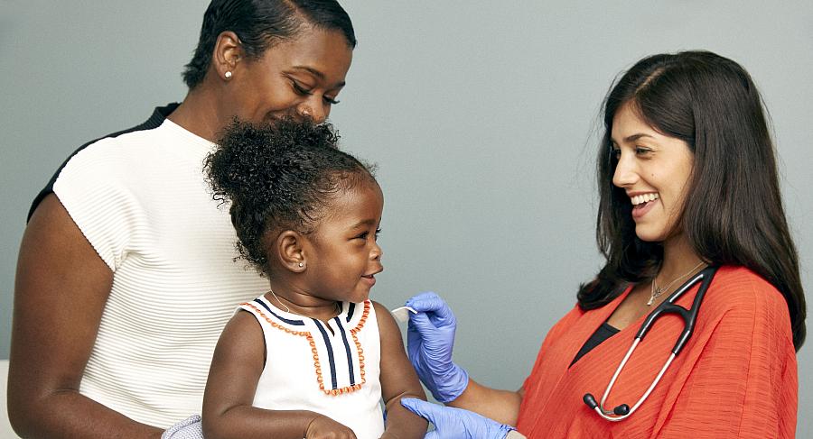 Toddler about to receive a vaccine from a doctor