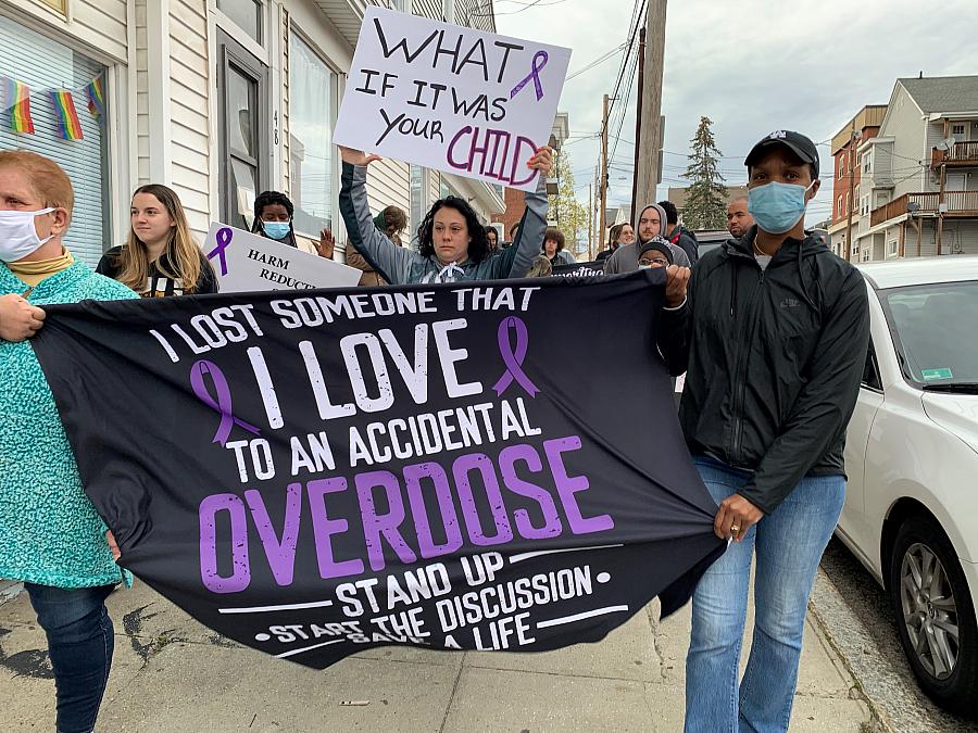 Protestors march to City Hall in Woonsocket, R.I. in April 2022.