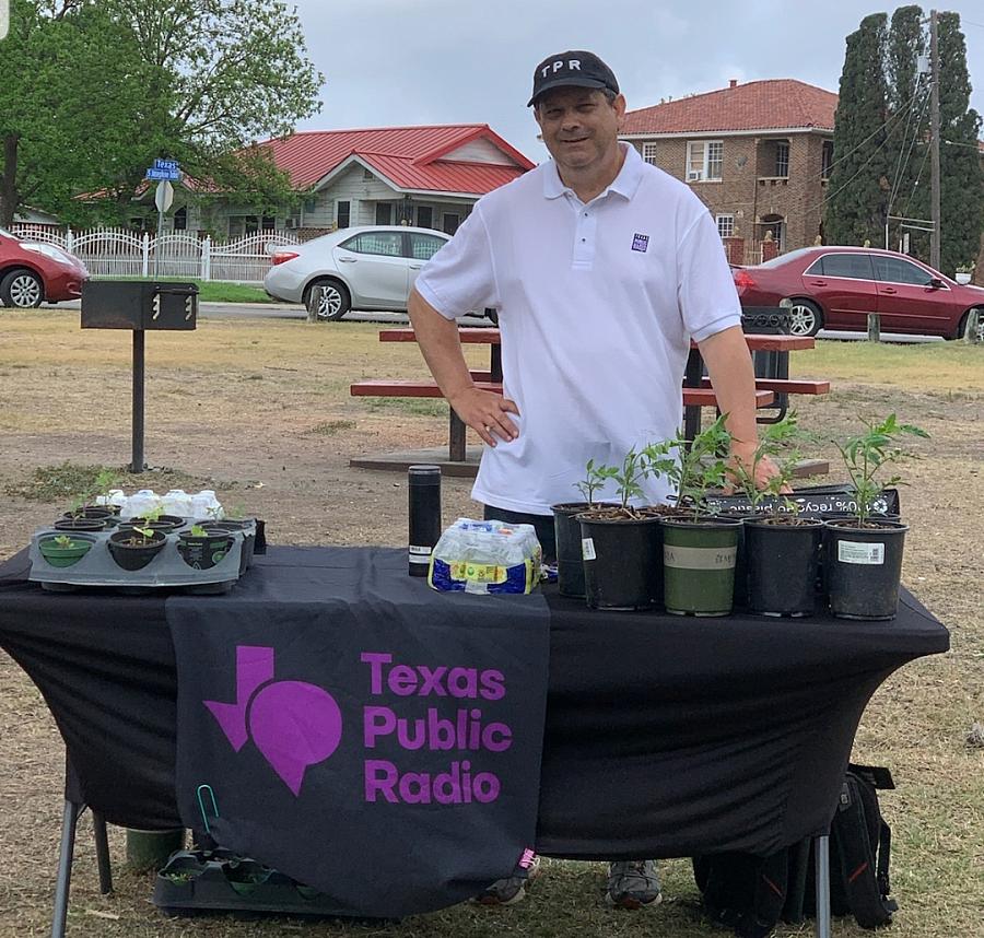 David Martin Davies stands at a table in a park near the West Side of San Antonio as part of an effort to meet people where they