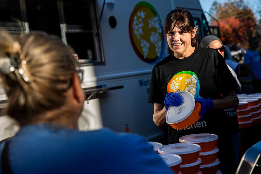 A volunteer serves food during a community meal event for the one-year anniversary of the November 2018 Camp Fire.