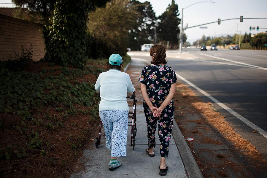 Ana Nicho Luu, 66, right, takes her mother, Maura Nicho, 90, who has Alzheimer’s disease, for a short walk around their Santa Cl