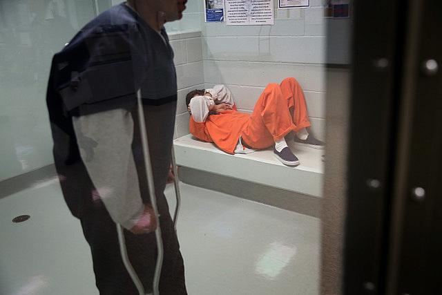 Immigrants wait in a processing cell at the Adelanto Detention Facility in Adelanto, California. (Photo: John Moore/Getty Images