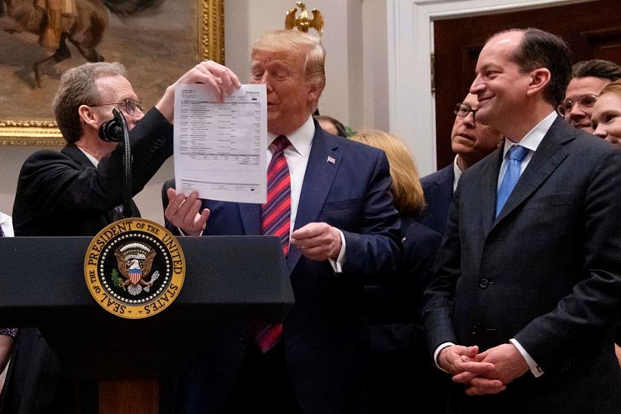 President Trump looks at a medical bill as he speaks during an event calling for legislation to end surprise medical billing at 