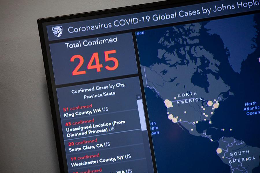 Outbreak map dashboard being used by officials to track the virus. (Photo by Samuel Corum/Getty Images)