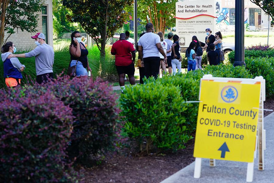 People stand in line to get tested for COVID-19 at a free walk-up testing site on July 11, 2020 in Atlanta, Georgia