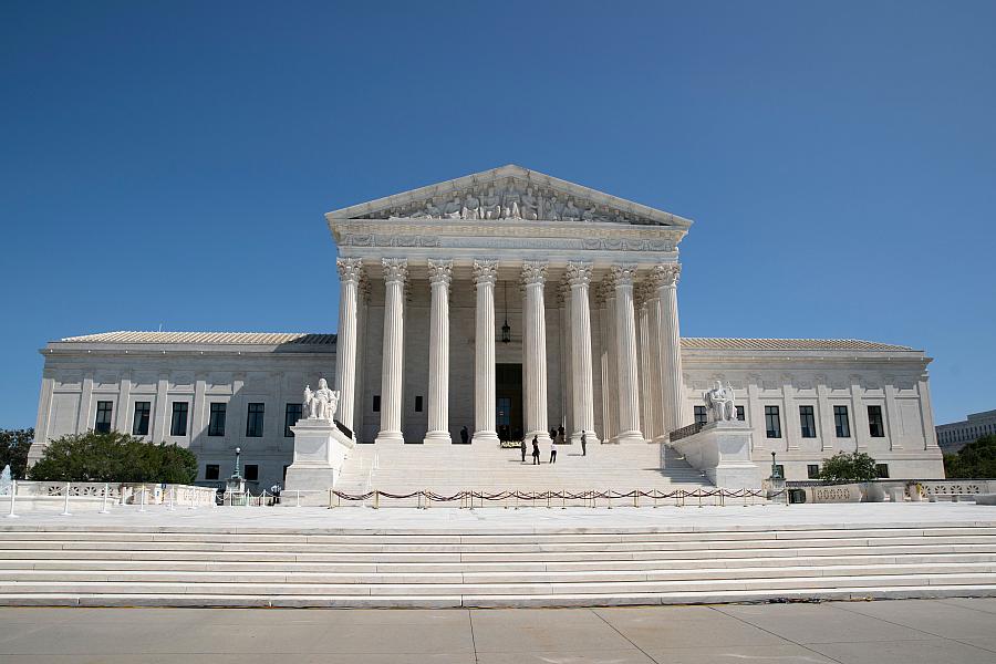 The Supreme Court building - a white building with roman columns. 