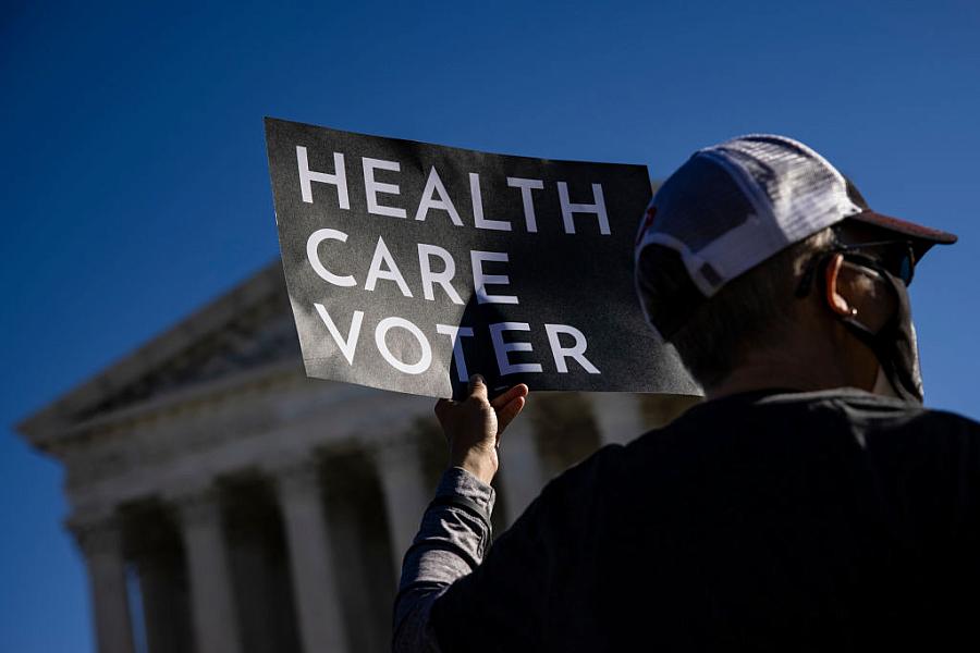 A supporter this of the Affordable Care Act in front of the Supreme Court, which heard arguments in the case against the ACA on 