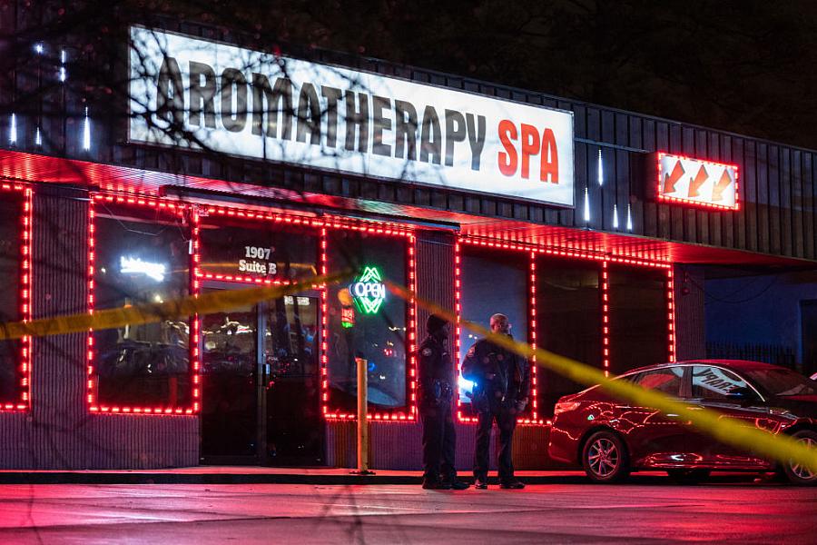 Law enforcement personnel are seen outside a massage parlor where a person was shot and killed on March 16, 2021, in Atlanta, GA