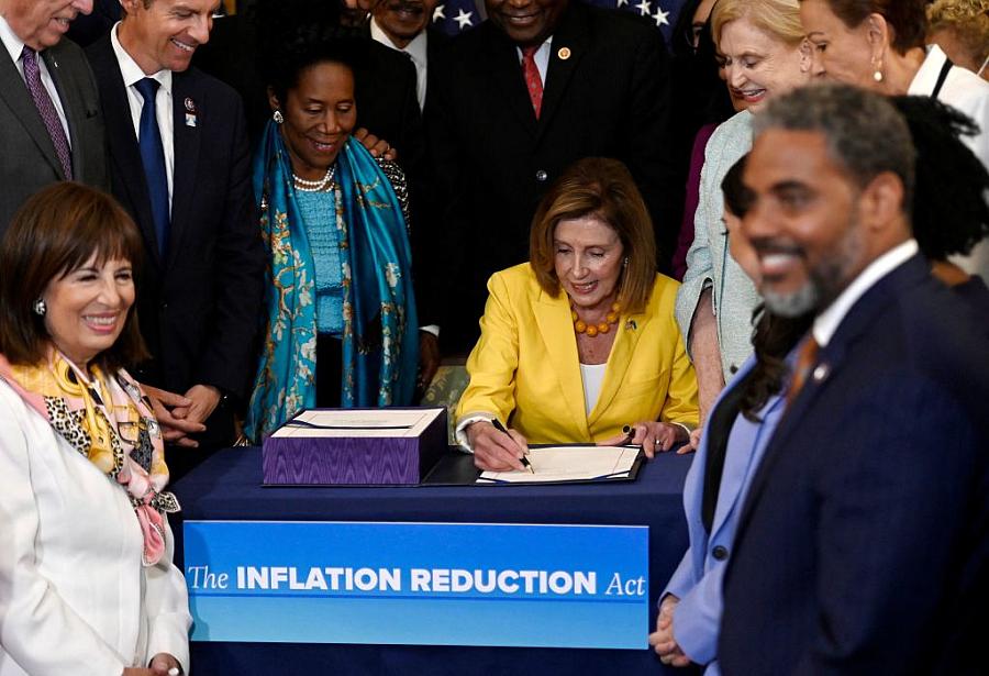 Speaker of the House Nancy Pelosi signs the Inflation Reduction Act after the House voted 220-207 to pass it at on August 12, 20