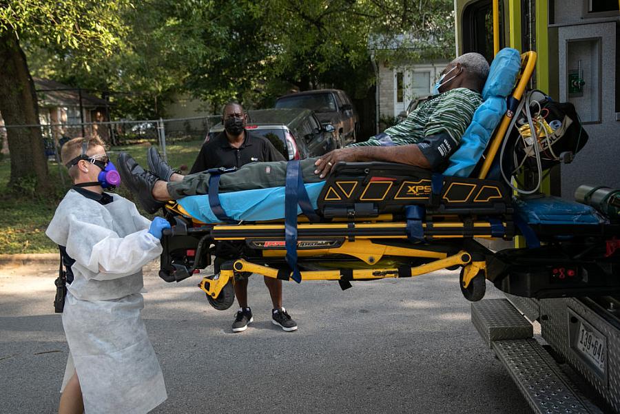 Medics transport a man with COVID-19 symptoms to the hospital in August 2020 in Austin, Texas.