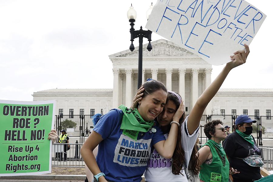  Abortion rights activists Carrie McDonald (L) and Soraya Bata react to the Dobbs v Jackson Women’s Health Organization ruling w