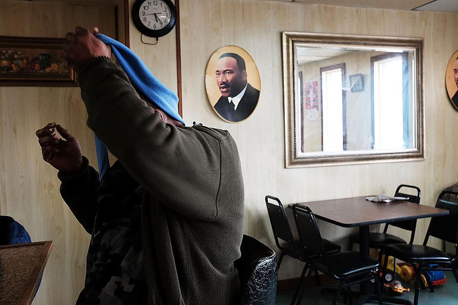 A man takes off his scarf at a restaurant in Biloxi, Mississippi. A man takes off his scarf at a restaurant in Biloxi, Mississippi.