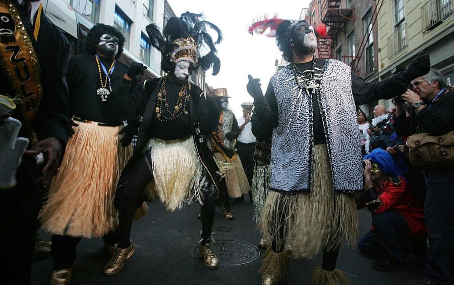 Members of the Zulu Social Aid and Pleasure Club dance in the French Quarter during Mardi Gras festivities in New Orleans