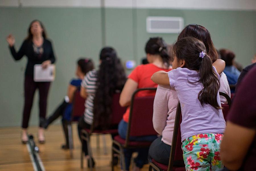 A girl watches during a workshop that teaches immigrants how to make a preparedness plan. (Photo: David McNew/AFP/Getty Images)