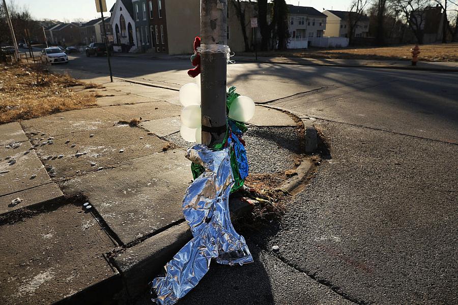 Deflated balloons hang from a lamppost where a person was killed in Baltimore, Maryland. Neighborhoods that lack quality schools