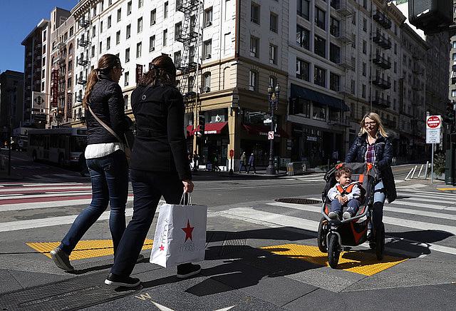 San Francisco residents wait in line for a food basket giveaway. (Photo by Justin Sullivan/Getty Images)