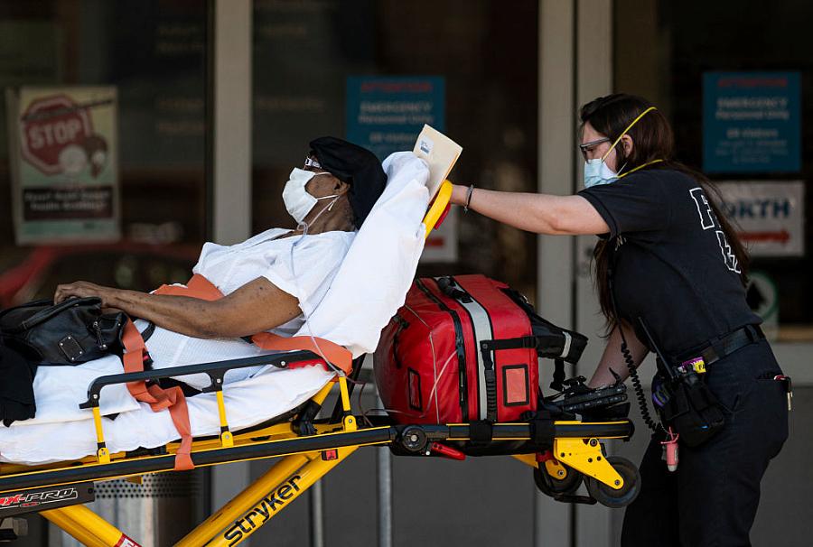 Medical workers transport a patient outside a special COVID-19 illness area at Maimonides Medical Center on May 17, 2020 in the 