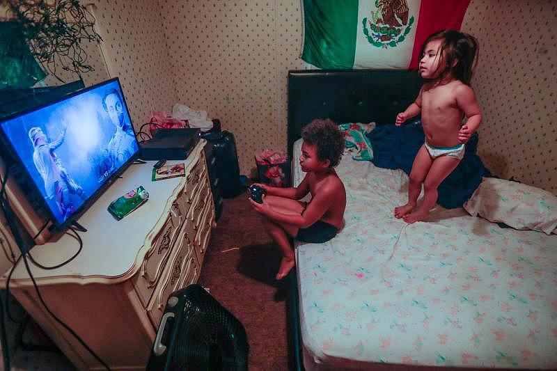 Romeo, 8, and his sister Victoria, 3, play in their mobile home. The family was among those profiled in the reporter’s series on