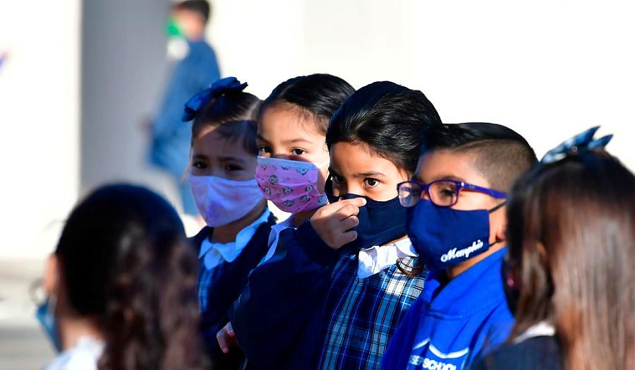 A student adjusts her facemask at St. Joseph Catholic School in La Puente, California in November 2020